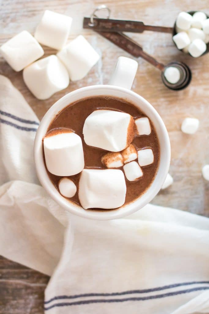 slow cooker peanut butter hot chocolate in a white mug topped with marshmallows
