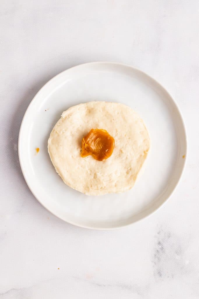 a flattened refrigerated biscuit with a softened caramel in the center