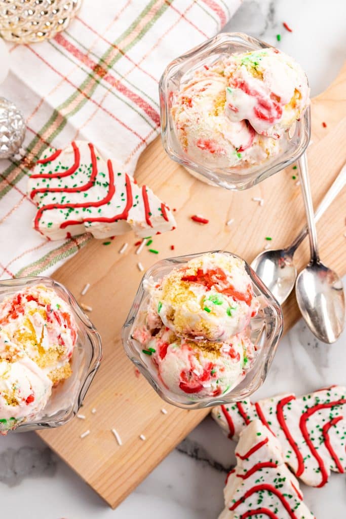 three scoops of copycat little debbie christmas tree cake ice cream in a glass ice cream bowl