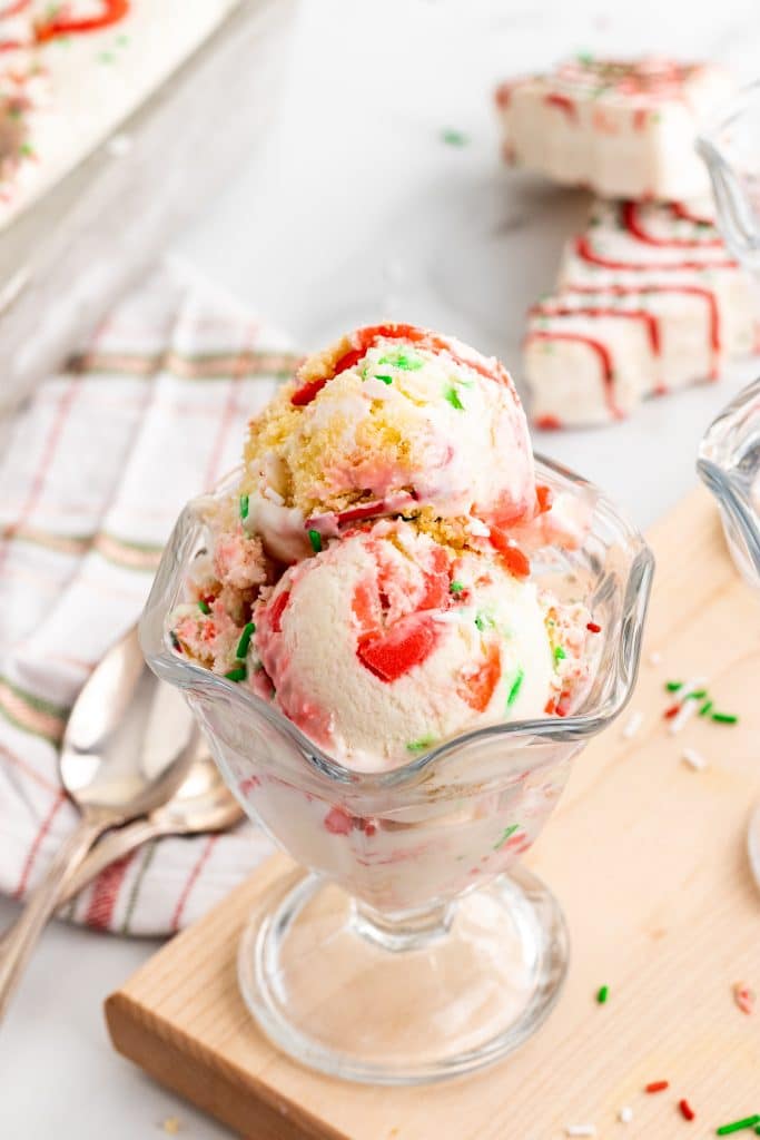 three scoops of copycat little debbie christmas tree cake ice cream in a glass ice cream bowl
