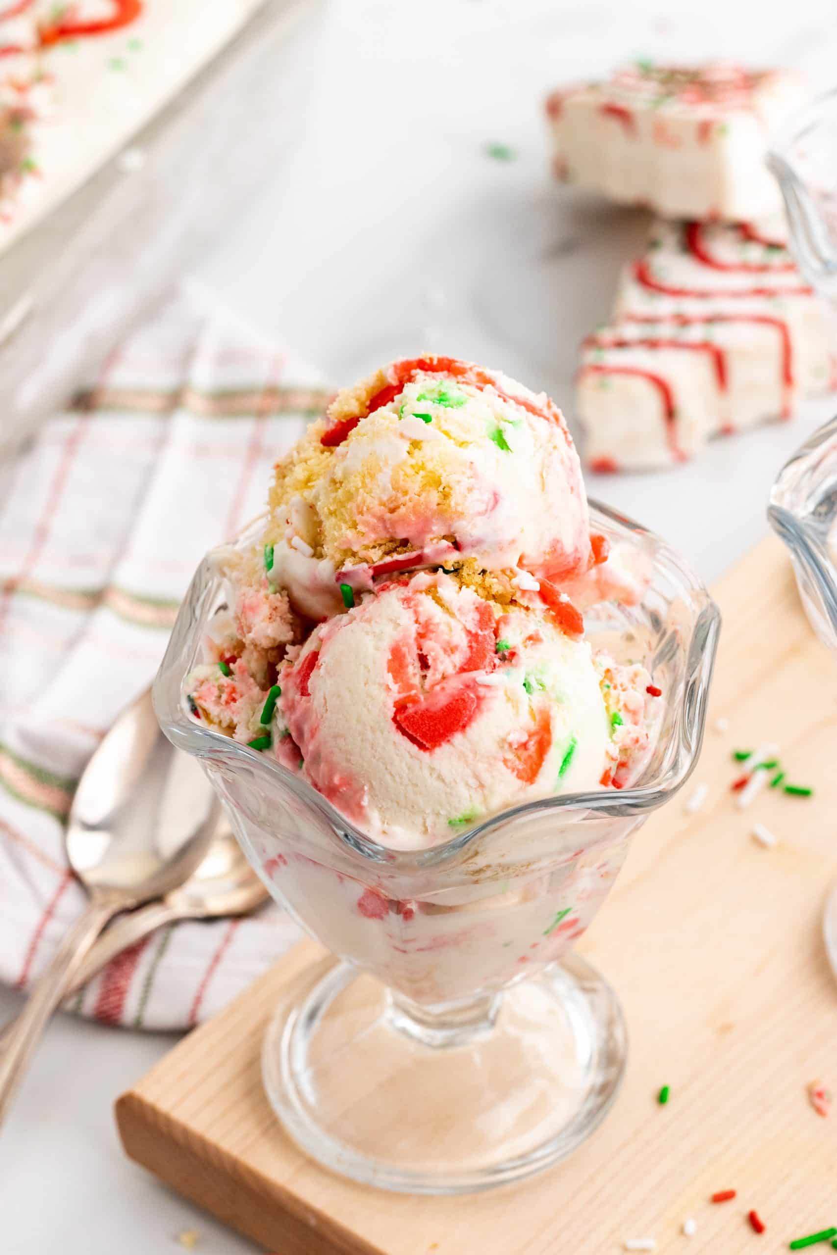 Copycat Little Debbie Christmas Tree Cake Ice Cream three scoops of copycat little debbie christmas tree cake ice cream in a glass ice cream bowl