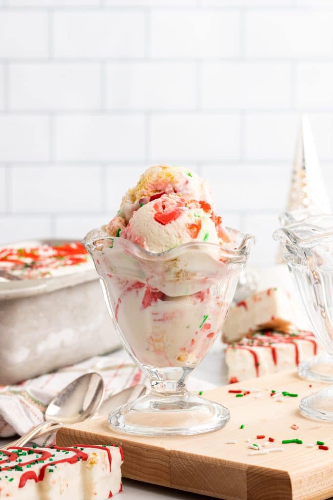 three scoops of copycat little debbie christmas tree cake ice cream in a glass ice cream bowl