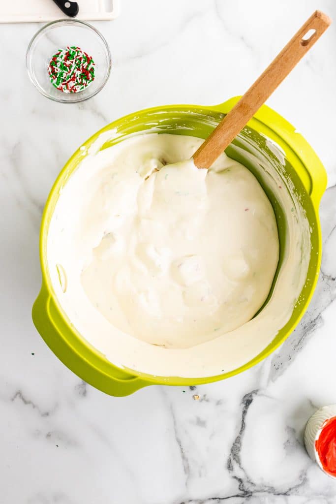 little debbie christmas tree cake ice cream mixture in a green mixing bowl
