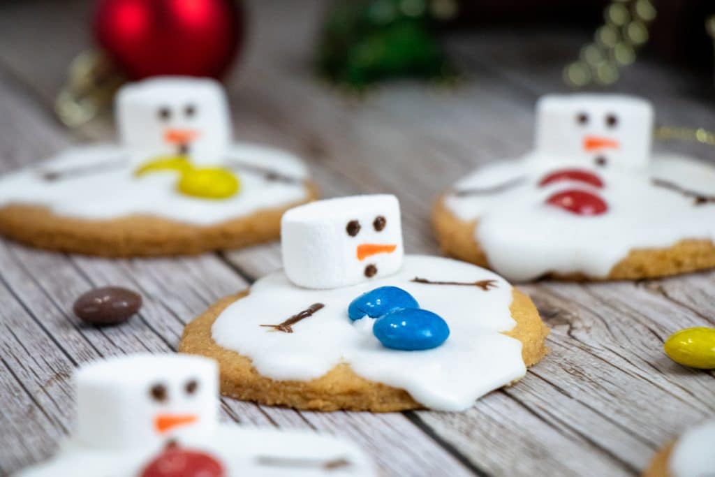 melted snowman cookies on a wooden table