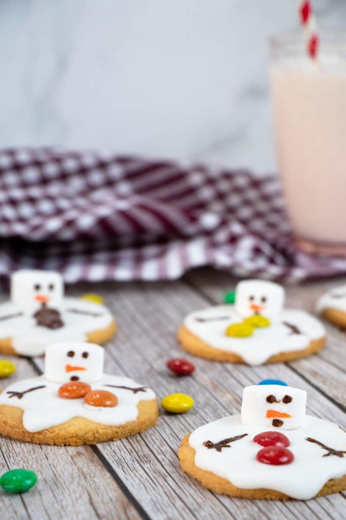 melted snowman cookies on a wooden table
