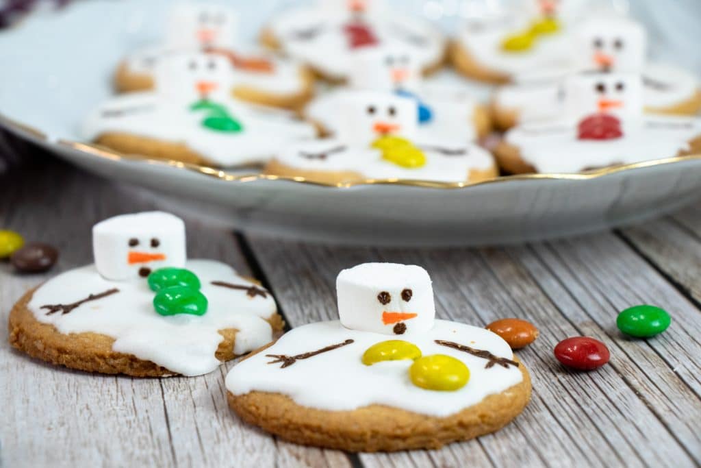melted snowman cookies on a wooden table