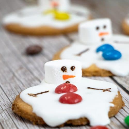 melted snowman cookies on a wooden table