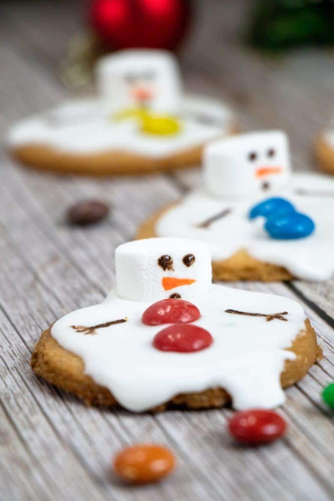 melted snowman cookies on a wooden table