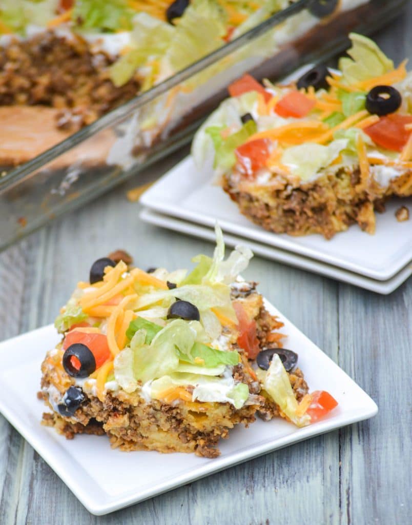 pieces of bisquick taco bake on two small white square plates