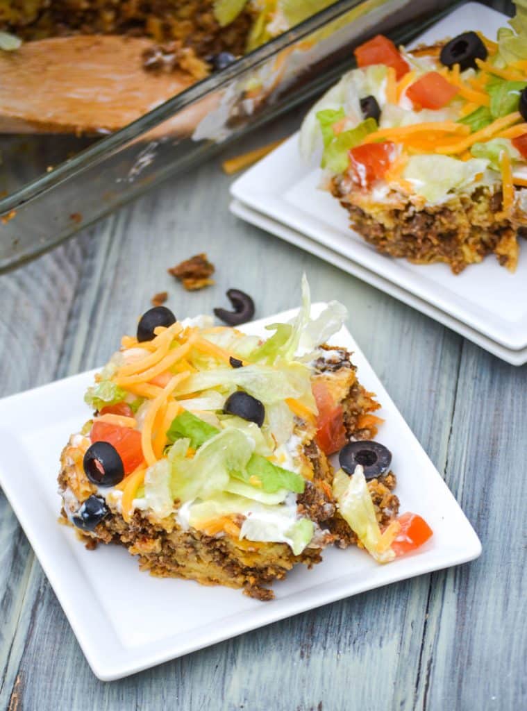 pieces of bisquick taco bake on two small white square plates