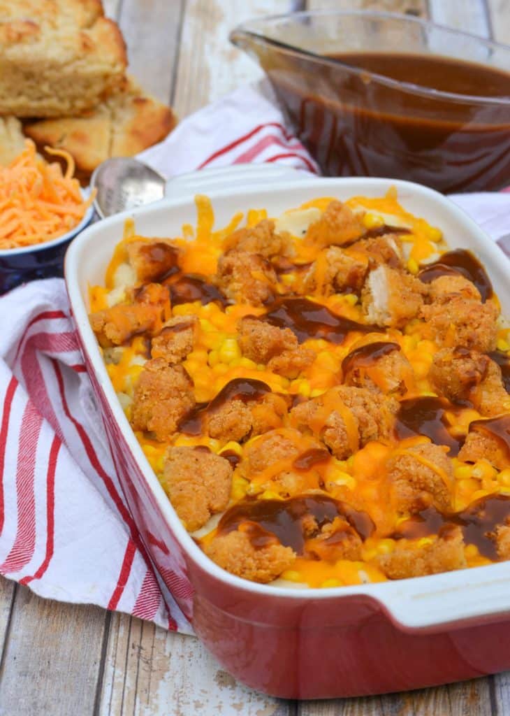 copycat kfc famous bowl casserole in a shallow red casserole dish