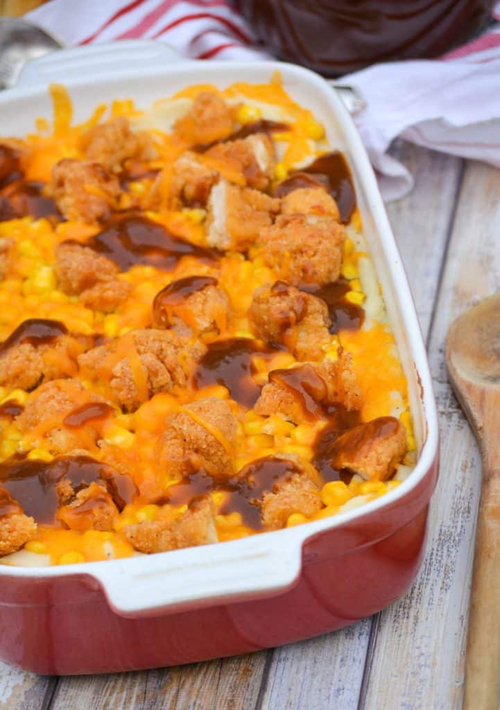 copycat kfc famous bowl casserole in a shallow red casserole dish