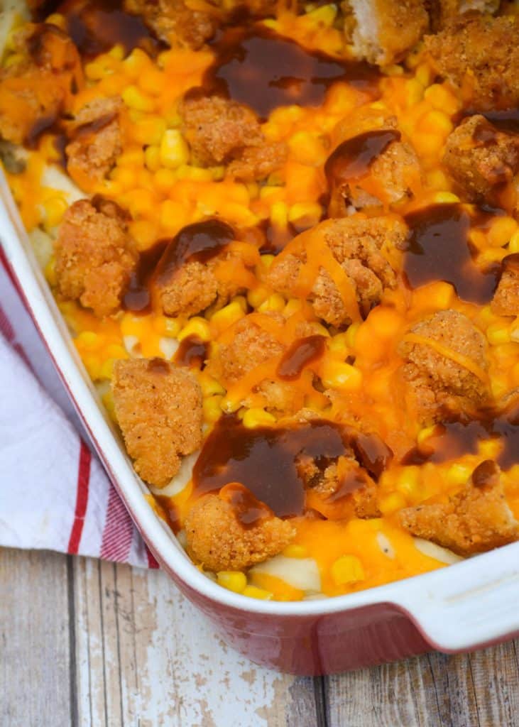 copycat kfc famous bowl casserole in a shallow red casserole dish