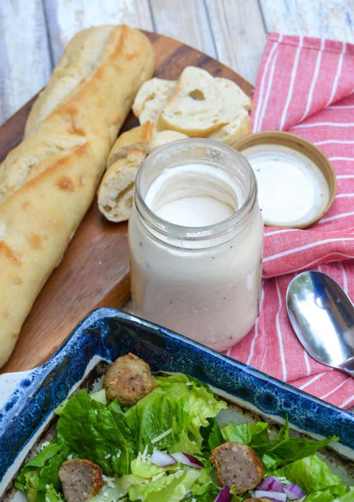 2 ingredient cream dressing in a glass mason jar next to an undressed salad