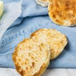 homemade english muffins on a blue cloth napkin