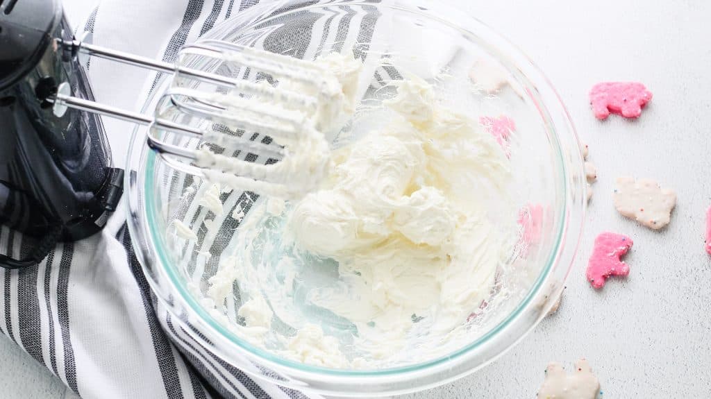 whipped cream cheese in a glass mixing bowl