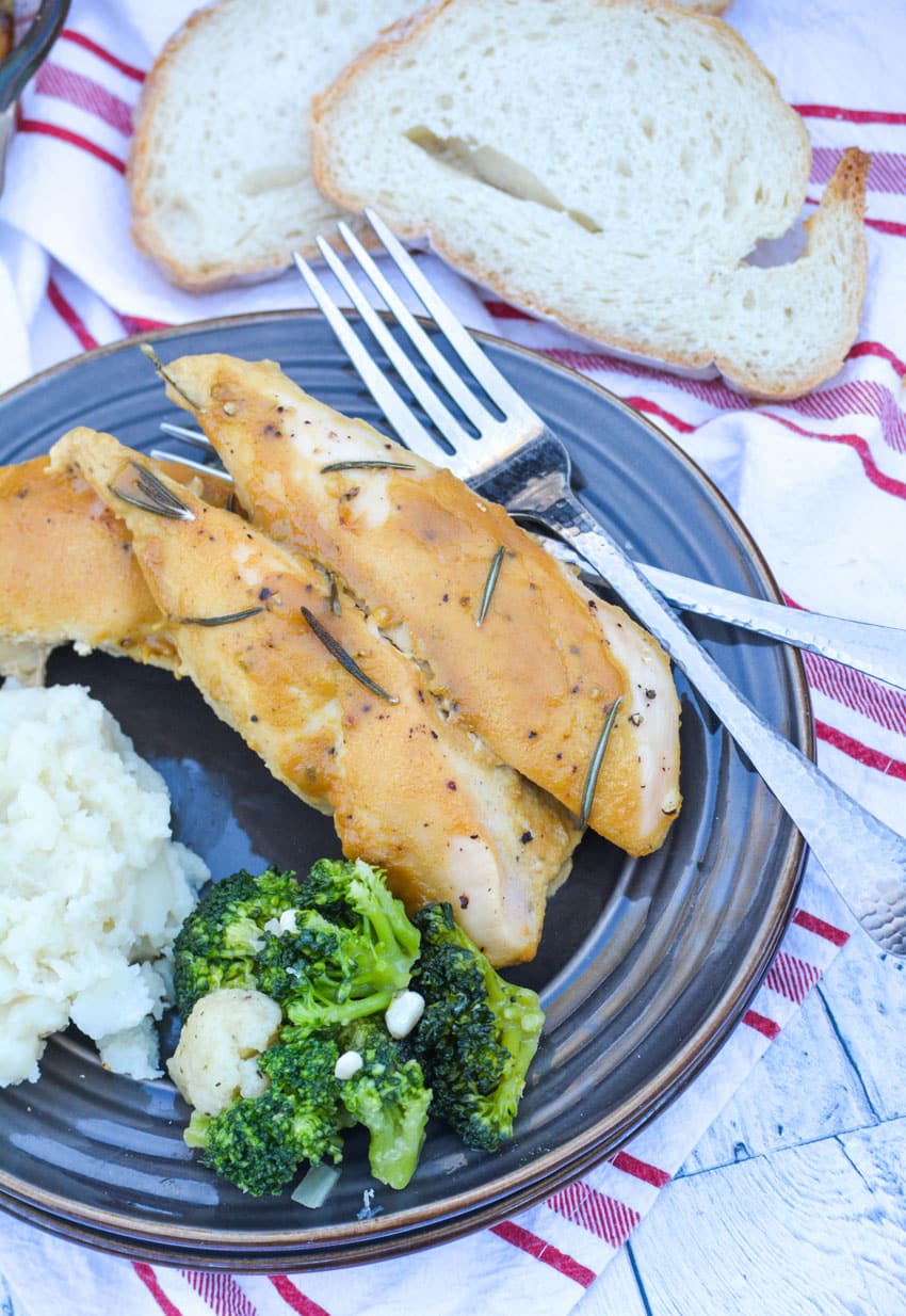 Marry Me Dijon Rosemary Chicken marry me dijon rosemary chicken served on a brown plate next to steamed broccoli and mashed potatoes with a silver fork on the side