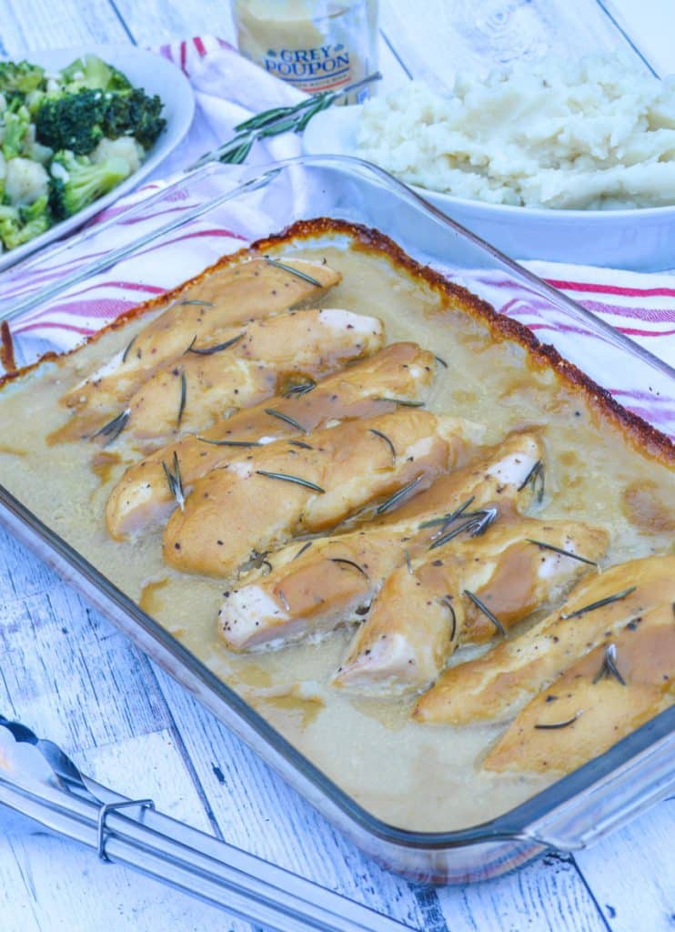 marry me dijon rosemary chicken bathed in sauce in a large glass baking dish