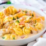 slow cooker crack chicken tortellini soup in a white bowl