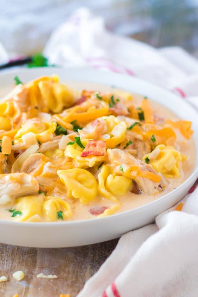 slow cooker crack chicken tortellini soup in a white bowl