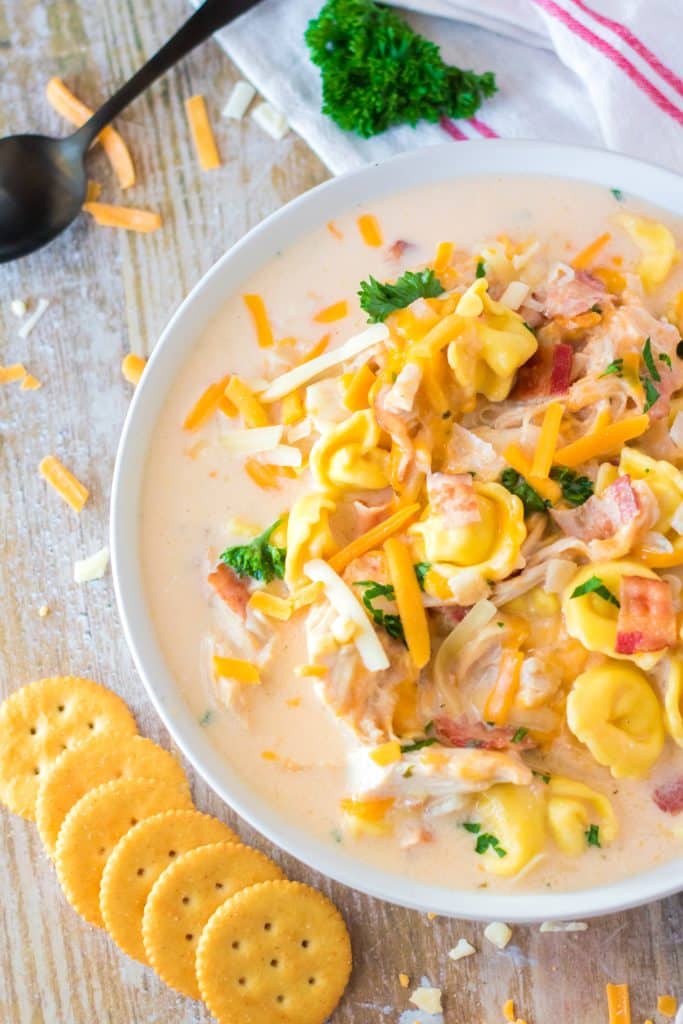 slow cooker crack chicken tortellini soup in a white bowl