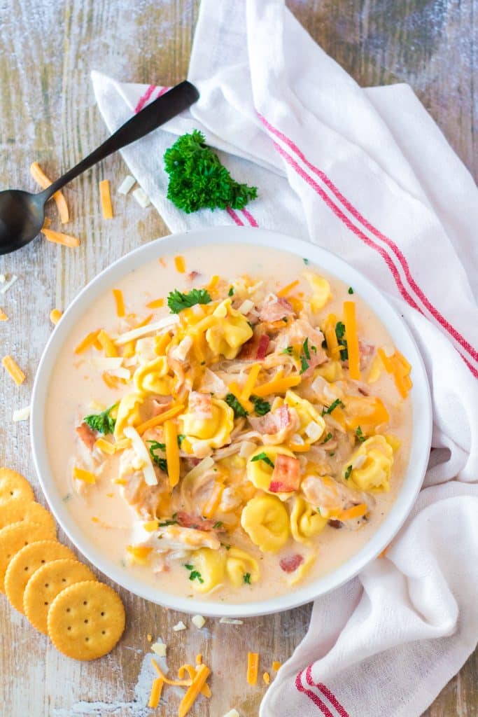 slow cooker crack chicken soup with tortellini in a white bowl