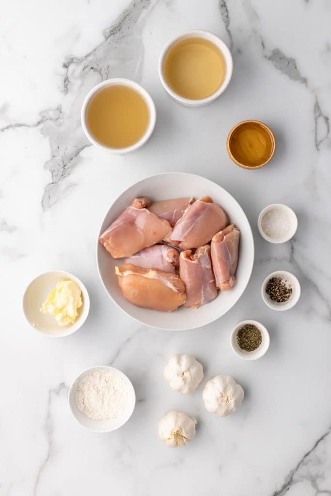 overhead image showing the measured ingredients needed to make pan seared chicken thighs with garlic gravy