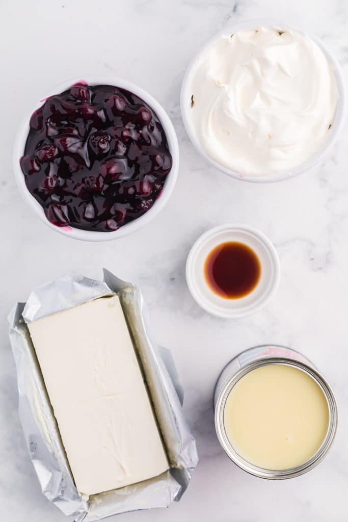 an overhead image showing the measured ingredients needed to make a batch of blueberry cheesecake dip
