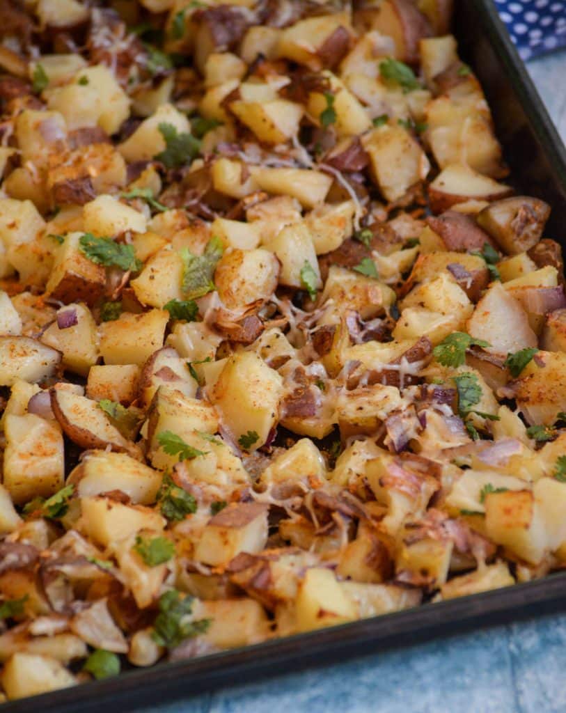 crispy old bay roasted potatoes on a metal baking sheet