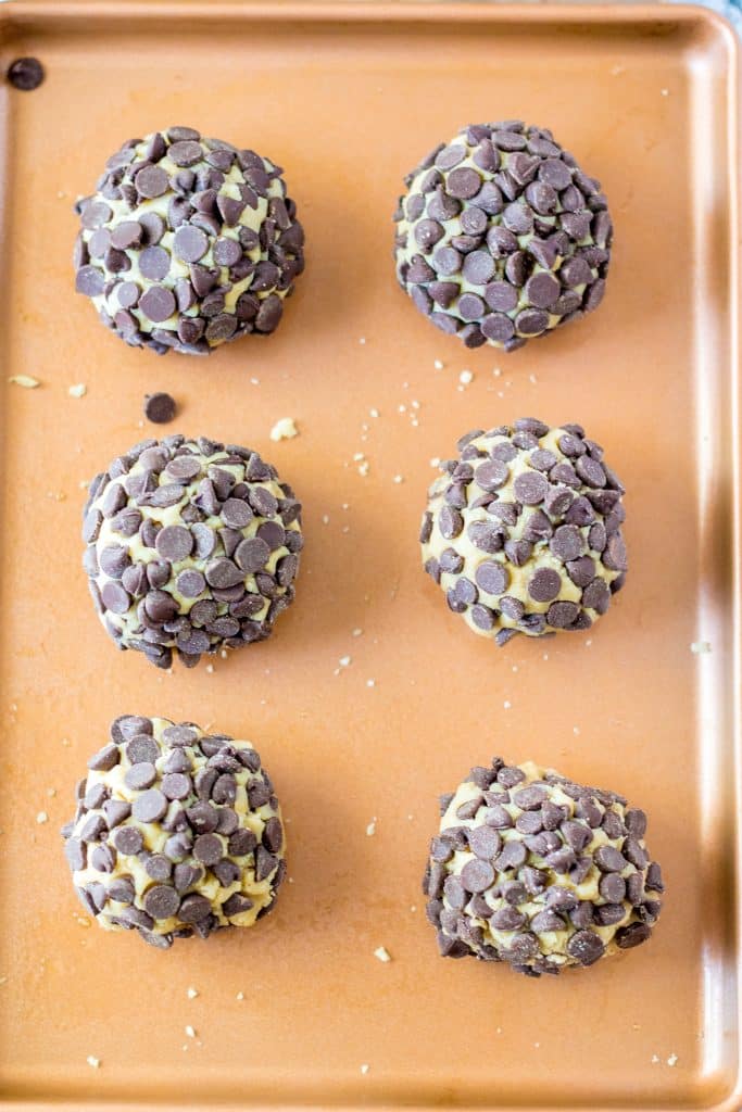 giant chocolate chip cookies dough balls covered in chocolate chips