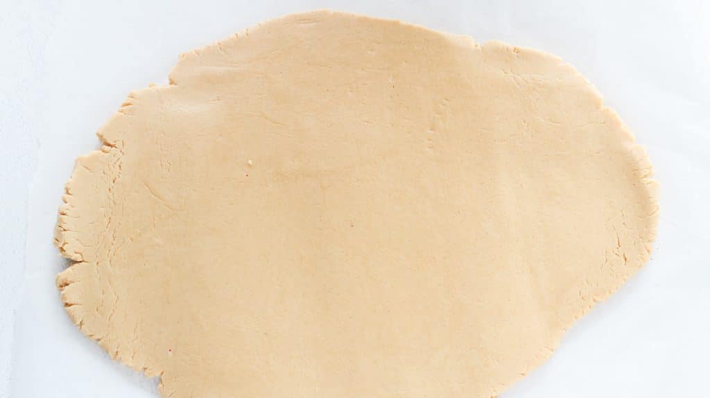 whipped peanut butter mousse rolled out flat on a white surface