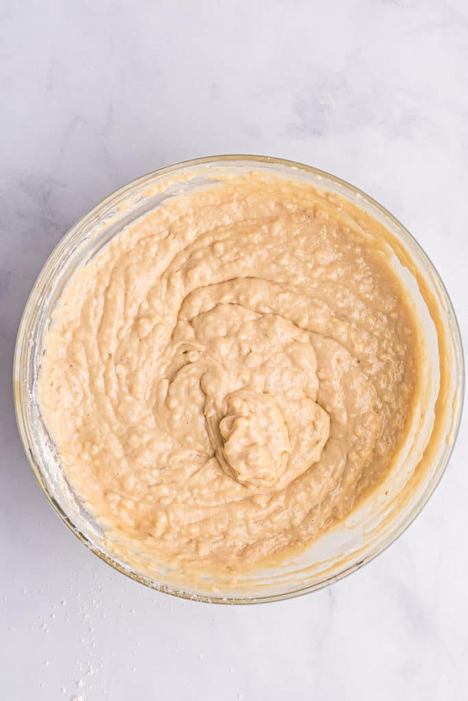 sheet pan peanut butter pancake batter in a glass mixing bowl