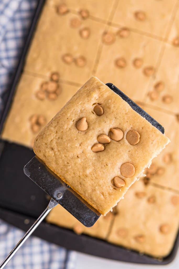 a spatula holding up a slice of sheet pan peanut butter pancakes
