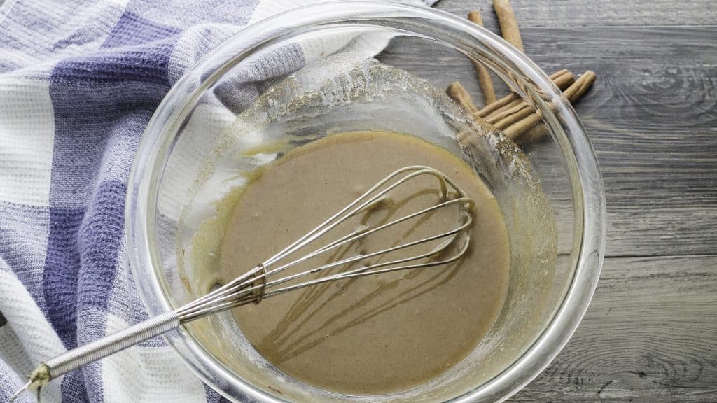 cinnamon filling in a glass mixing bowl with a silver whisk