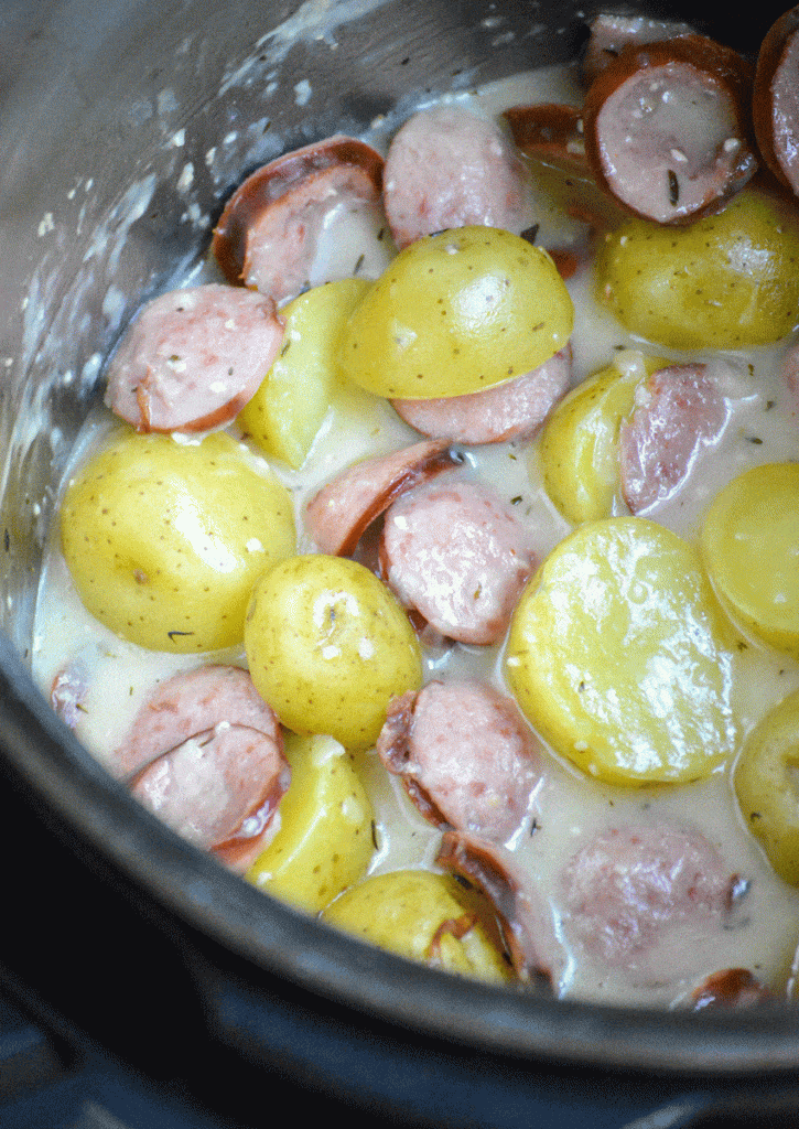 creamy potatoes and sliced of smoked sausage in the liner of an Instant pot