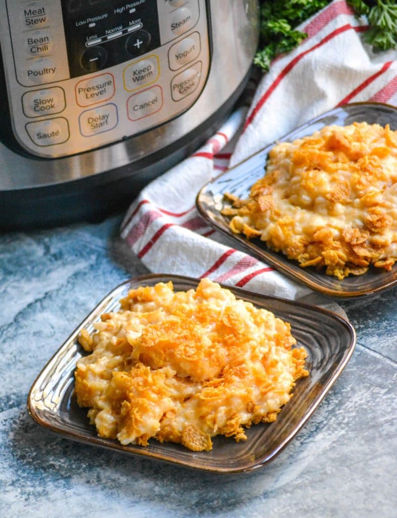 Instant pot funeral potatoes on small brown plates sitting in front of a pressure cooker