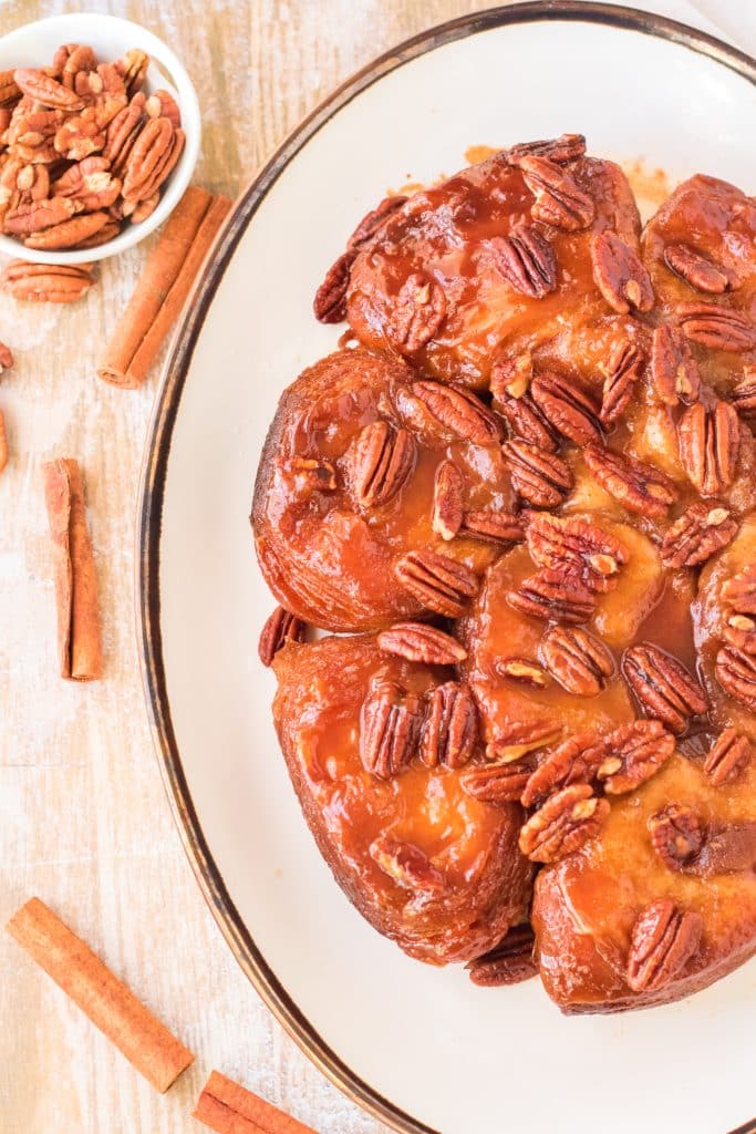 slow cooker sticky buns on a white oval serving platter