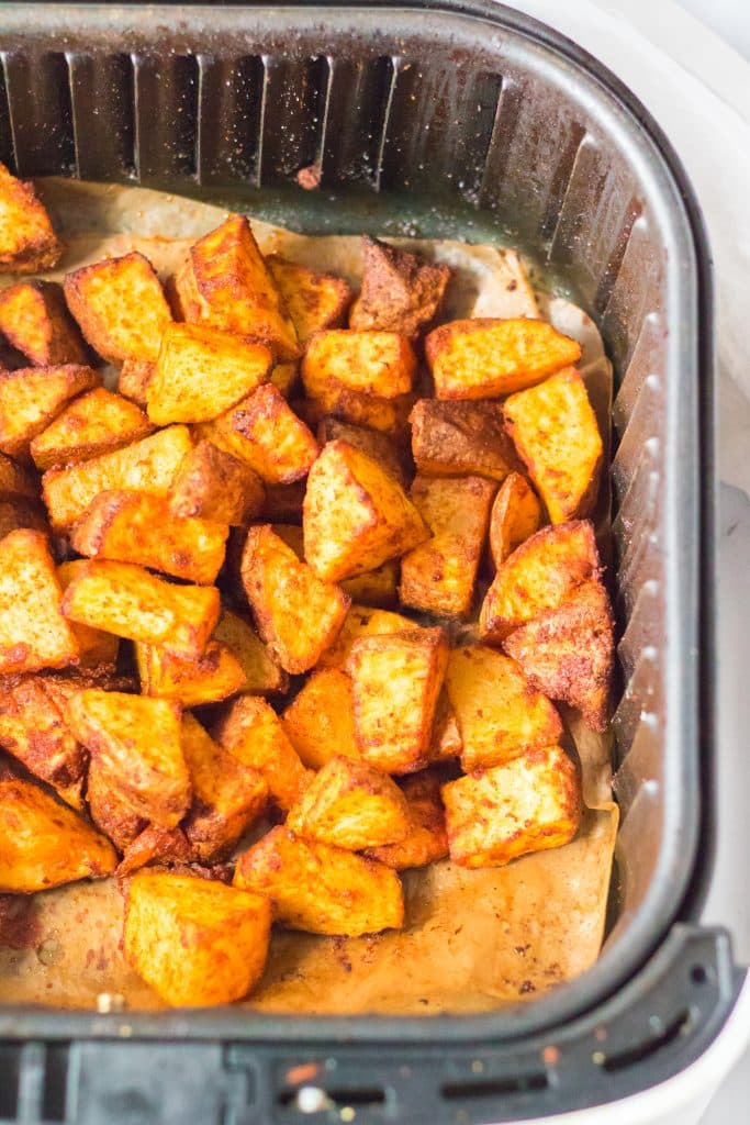 cooked fiesta seasoned potatoes in the basket of an air fryer