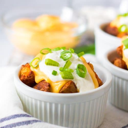 cheesy air fryer potatoes in a white ramekin