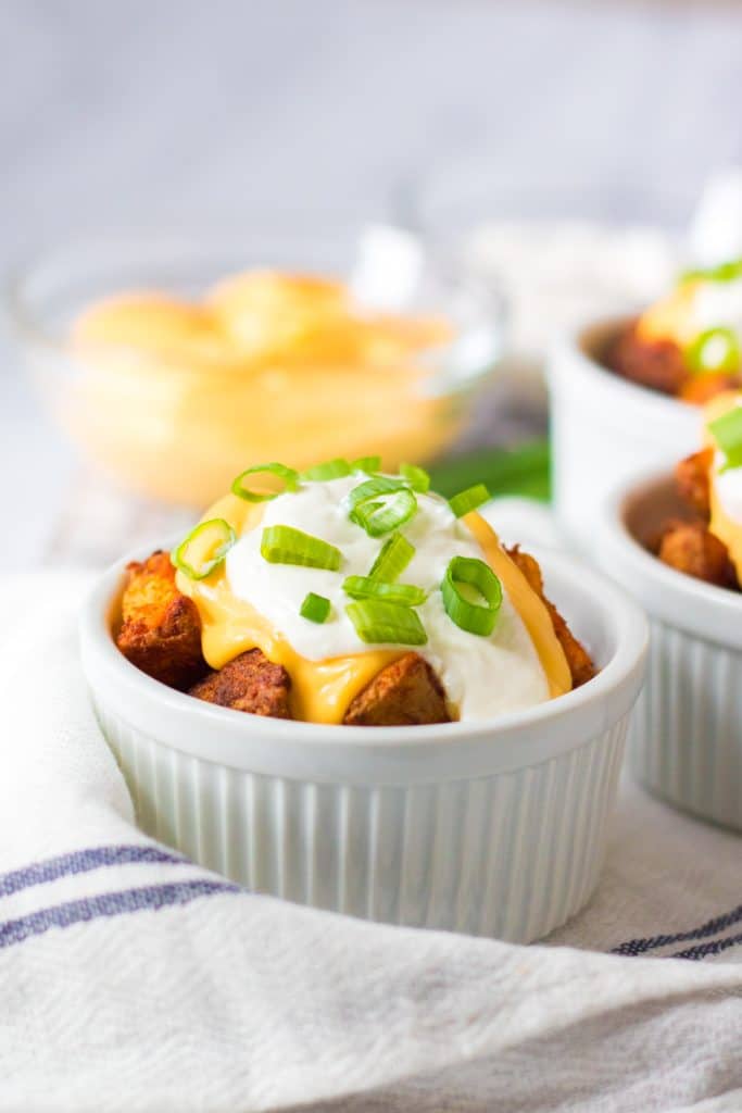 cheesy air fryer potatoes in a white ramekin