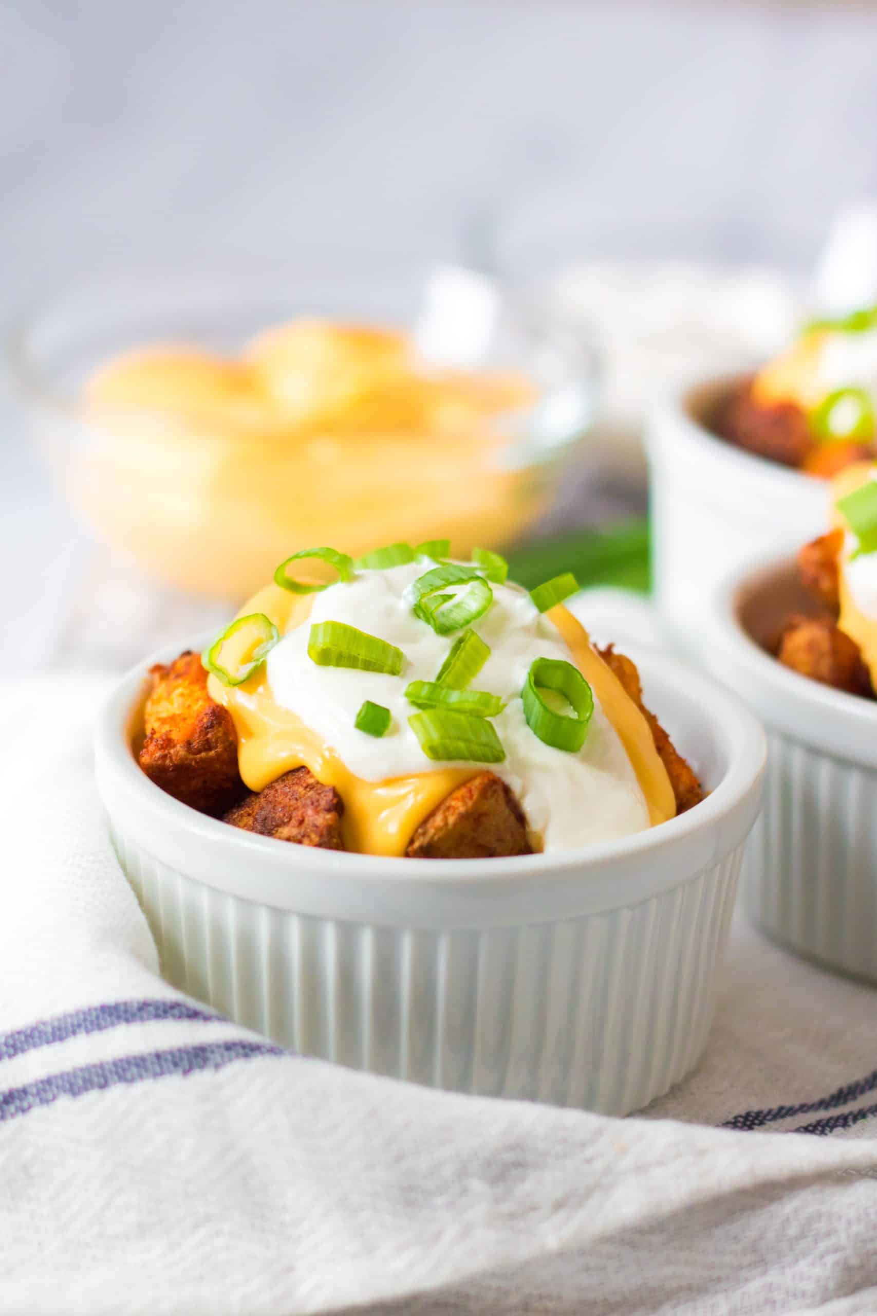 cheesy air fryer potatoes in a white ramekin