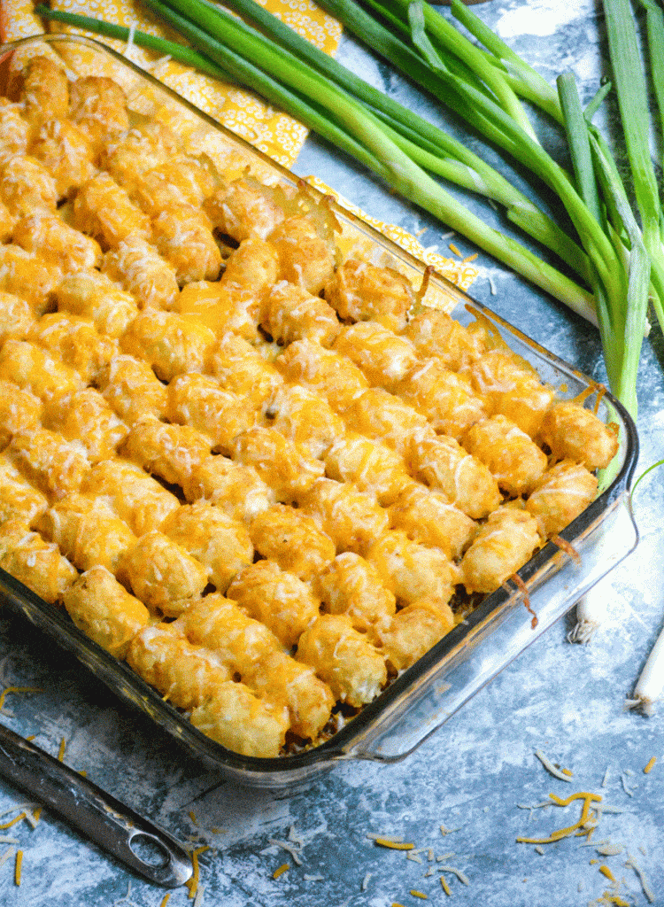 cheeseburger tater tot casserole in a 9x13" glass baking dish