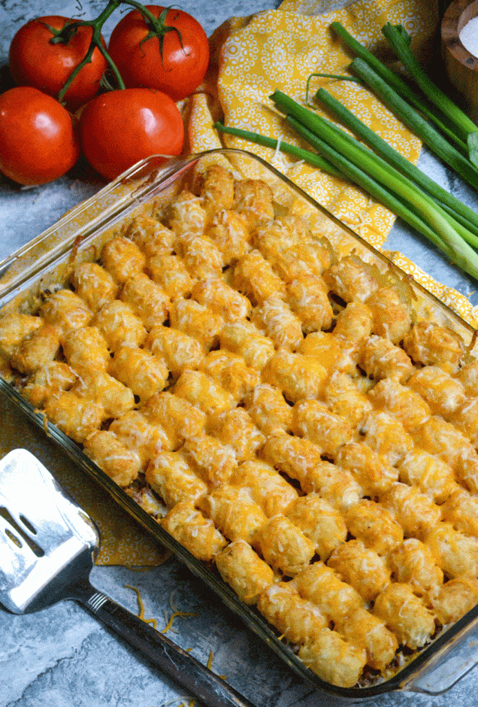 cheeseburger tater tot casserole in a 9x13" glass baking dish