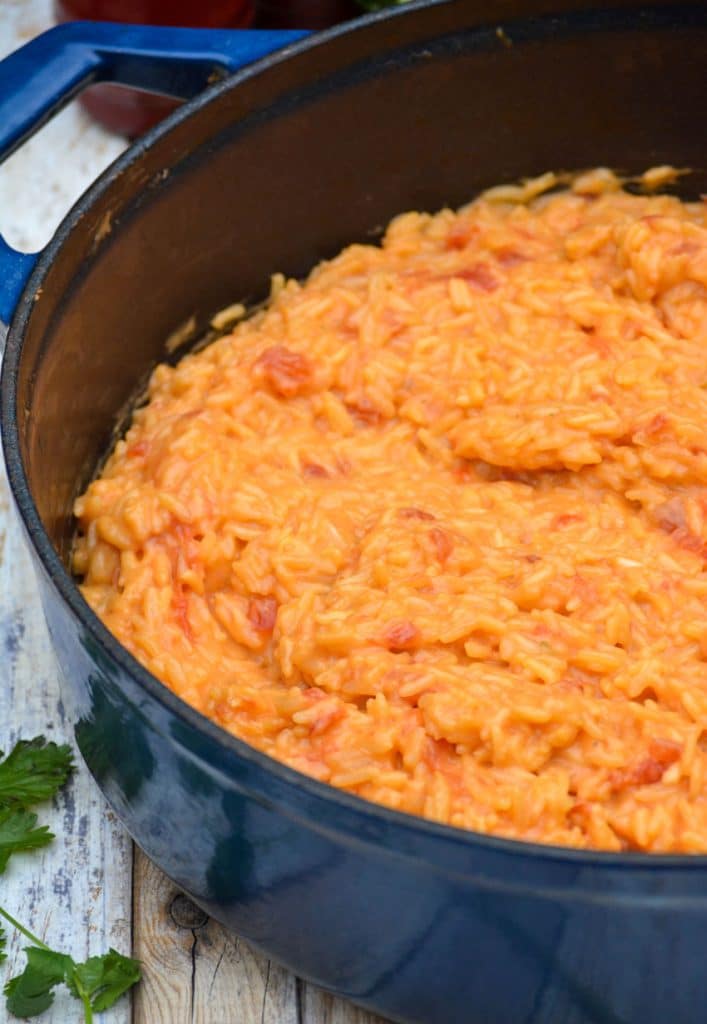 cheesy queso rice in a blue enameled cast iron dutch oven