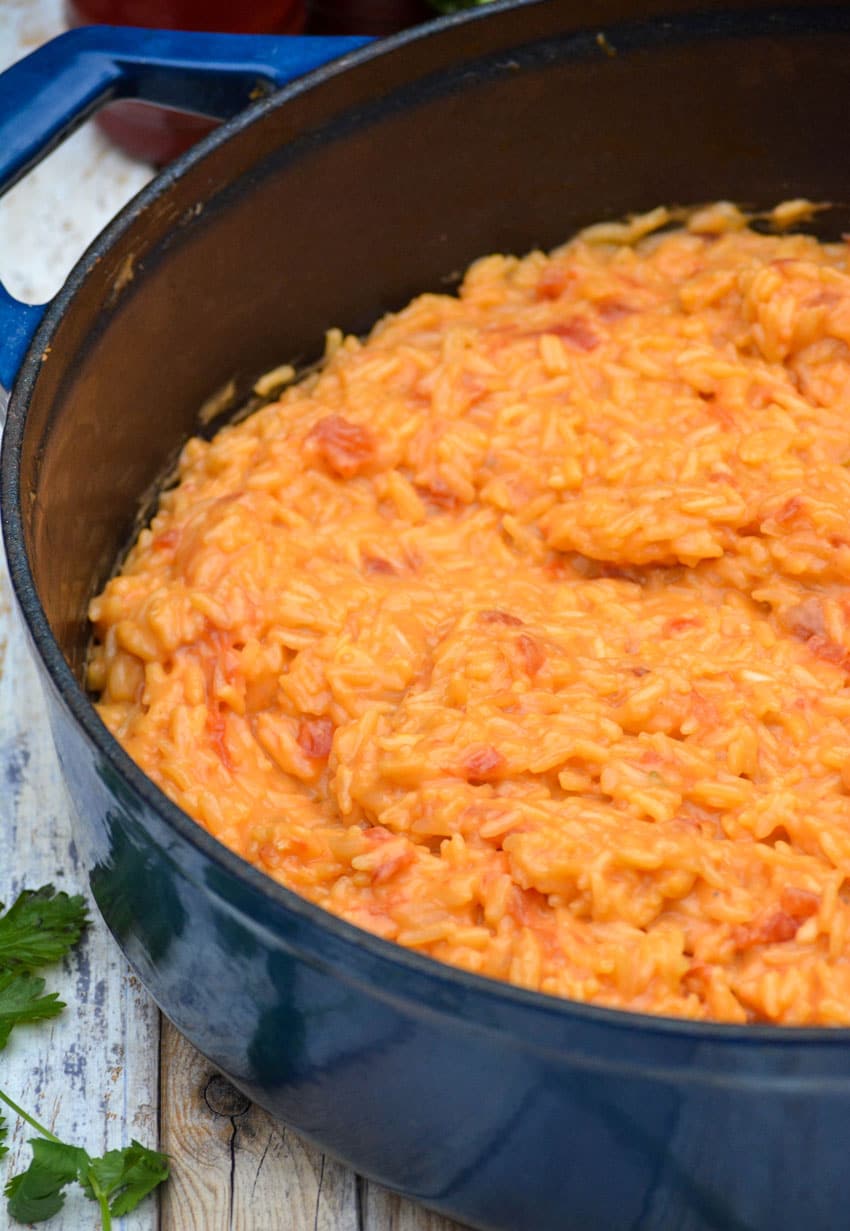 cheesy queso rice in a blue enameled cast iron dutch oven