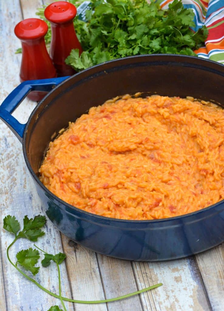 cheesy queso rice in a blue enameled cast iron dutch oven
