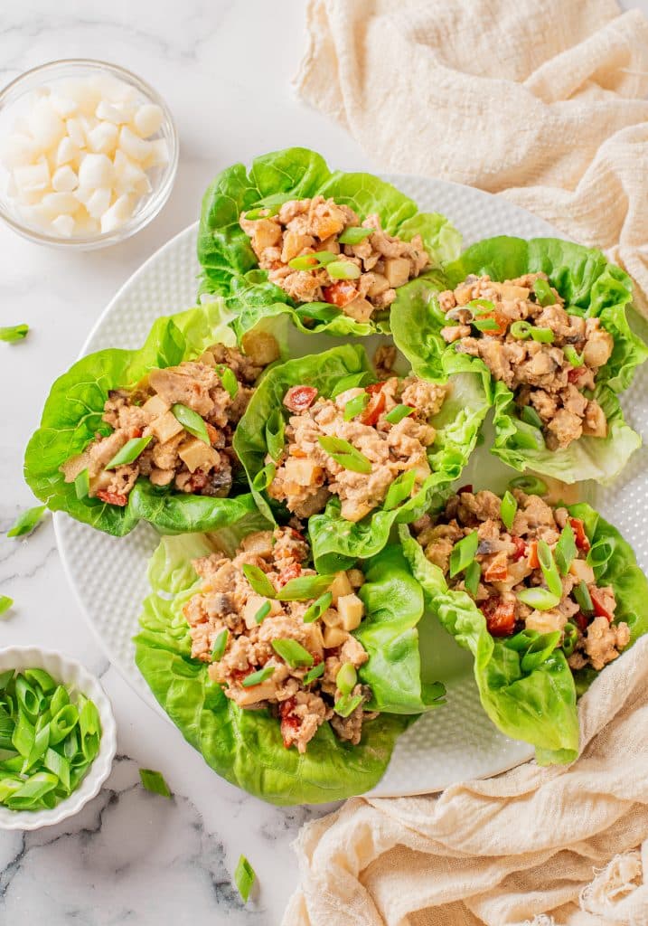 chicken lettuce wraps on a white plate