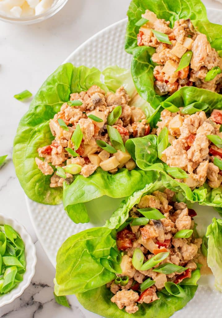 chicken lettuce wraps on a white plate