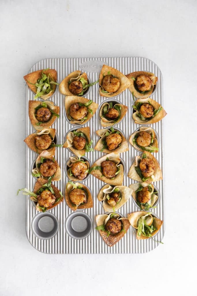 baked shrimp taco cups in a small silver muffin tin