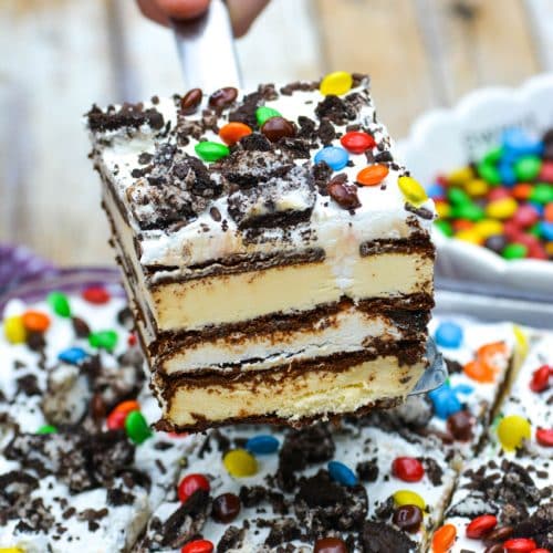 a silver spatula lifting a slice of ice cream sandwich cake from a baking dish